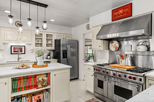 kitchen with decorative backsplash, a sink, extractor fan, and appliances with stainless steel finishes