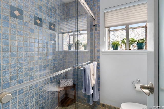 full bath featuring toilet and tiled shower