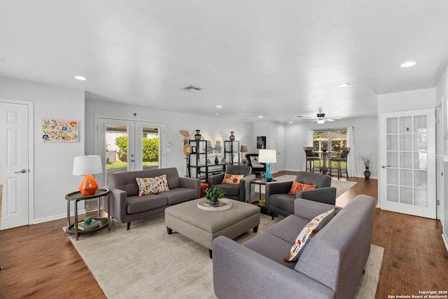 living room featuring recessed lighting, wood finished floors, visible vents, and french doors