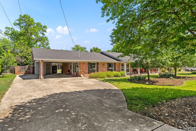 single story home with brick siding, driveway, a front yard, and fence