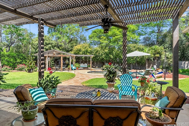 view of patio / terrace featuring a pergola, a ceiling fan, and an in ground hot tub