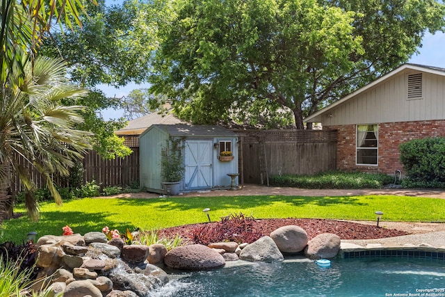 view of yard featuring fence, an outbuilding, and a storage shed