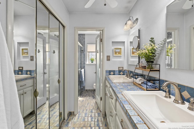 full bathroom featuring toilet, ceiling fan, and a sink