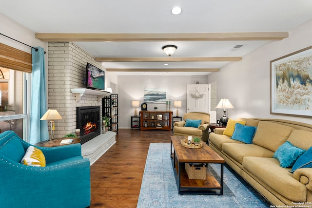 living area featuring wood finished floors, beamed ceiling, a fireplace, visible vents, and recessed lighting