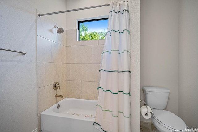 bathroom featuring shower / bath combo and toilet