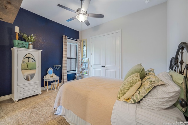 bedroom featuring carpet, a closet, baseboards, and a ceiling fan