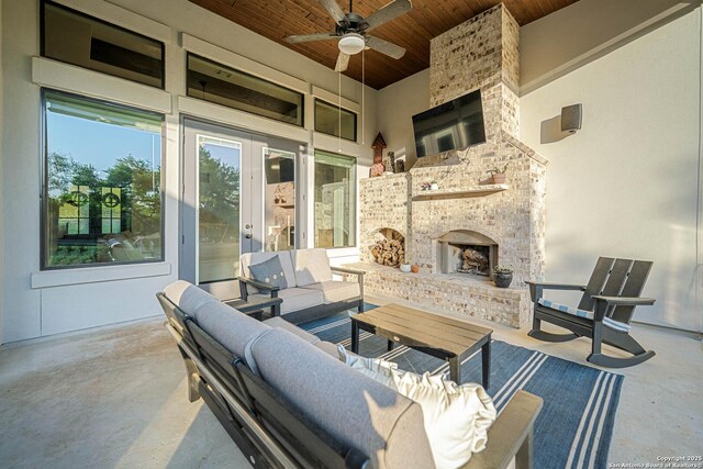 view of patio featuring an outdoor living space with a fireplace and ceiling fan