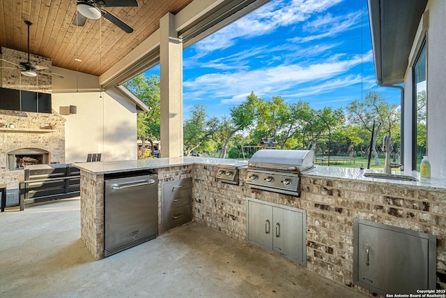 view of patio / terrace featuring exterior kitchen, a sink, a grill, and a ceiling fan