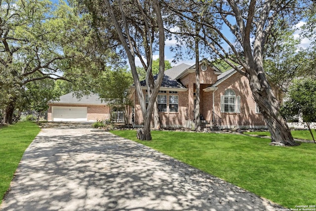 628 Mission Vw, New Braunfels, TX 78130 - traditional home with brick siding, a front yard, a garage, and aphalt driveway