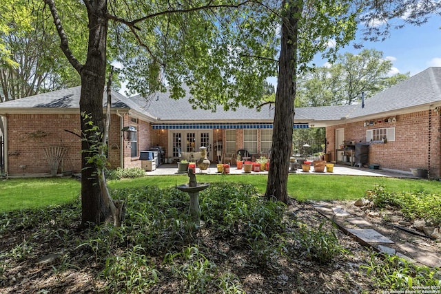 628 Mission Vw, New Braunfels, TX 78130 - rear view of house with a patio, a lawn, and brick siding