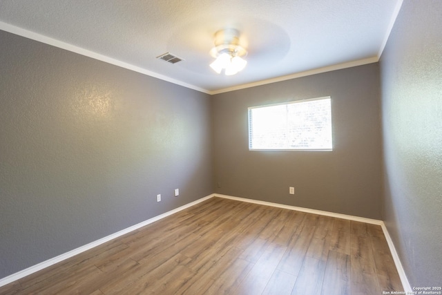 16427 Kentucky, Selma, TX 78154 - spare room with crown molding, visible vents, a ceiling fan, and wood finished floors