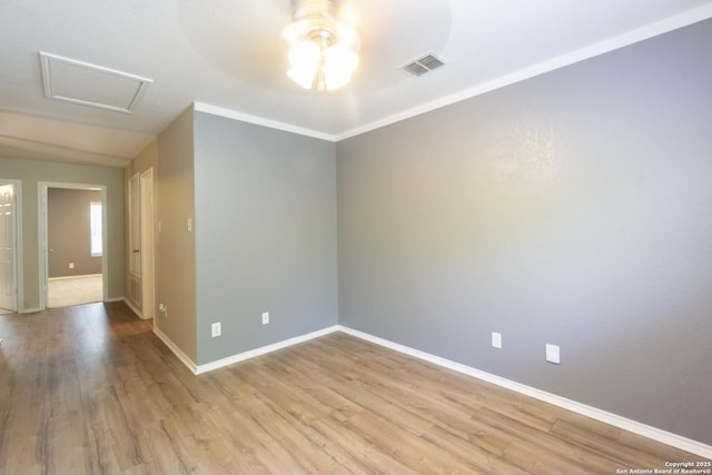 16427 Kentucky, Selma, TX 78154 - empty room featuring visible vents, baseboards, attic access, and light wood-style floors