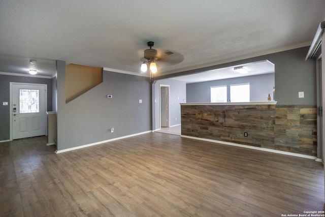 16427 Kentucky, Selma, TX 78154 - unfurnished living room featuring crown molding, baseboards, a ceiling fan, and wood finished floors