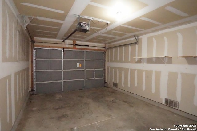 garage with visible vents and a garage door opener