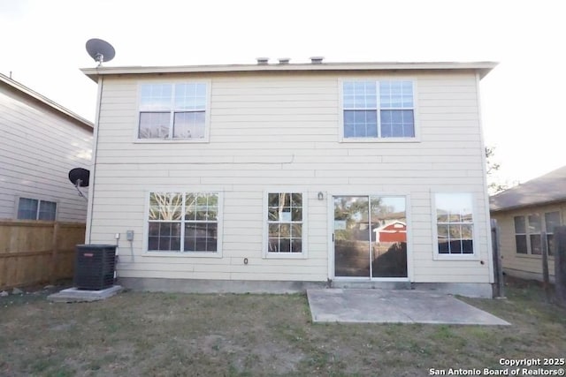 rear view of house with a yard, a patio area, fence, and central AC unit
