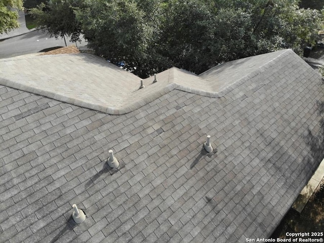 exterior details featuring a shingled roof