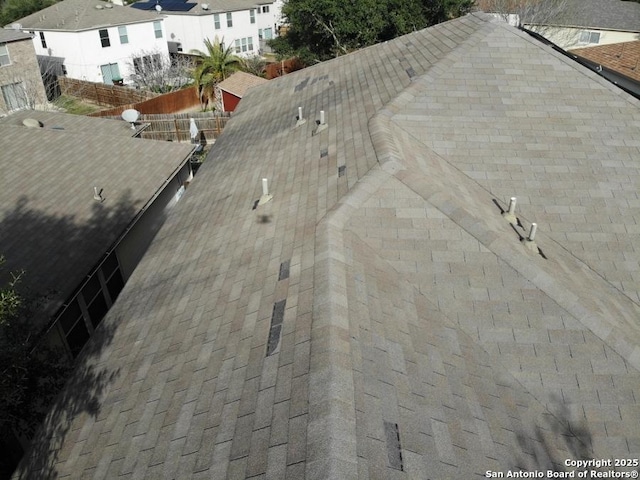 details with roof with shingles and fence