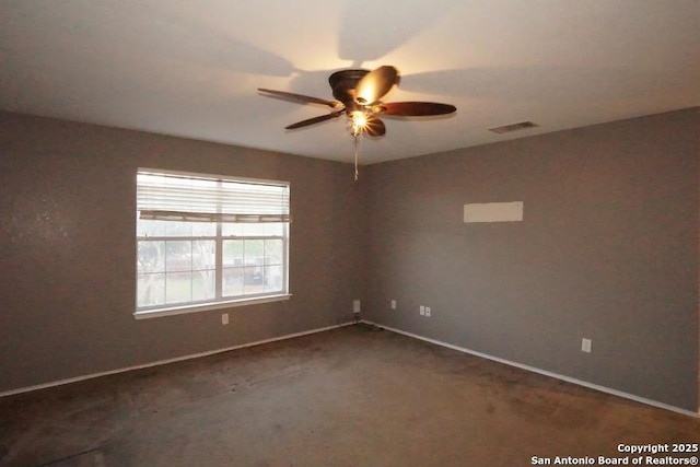 spare room featuring carpet, visible vents, baseboards, and ceiling fan
