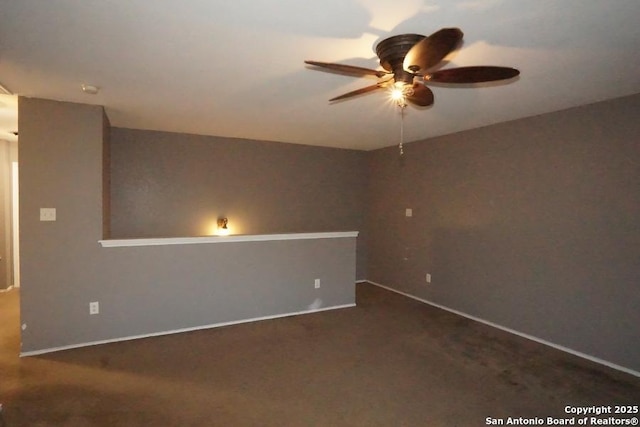 spare room with baseboards and a ceiling fan