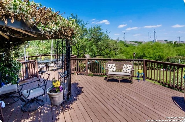 wooden terrace featuring outdoor dining area