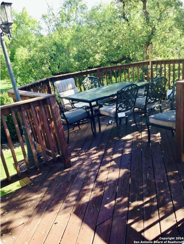wooden terrace featuring outdoor dining area