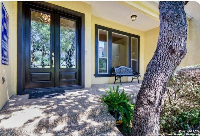 entrance to property with french doors and stucco siding
