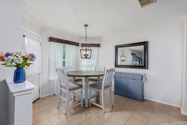 dining space featuring baseboards, crown molding, visible vents, and light tile patterned floors