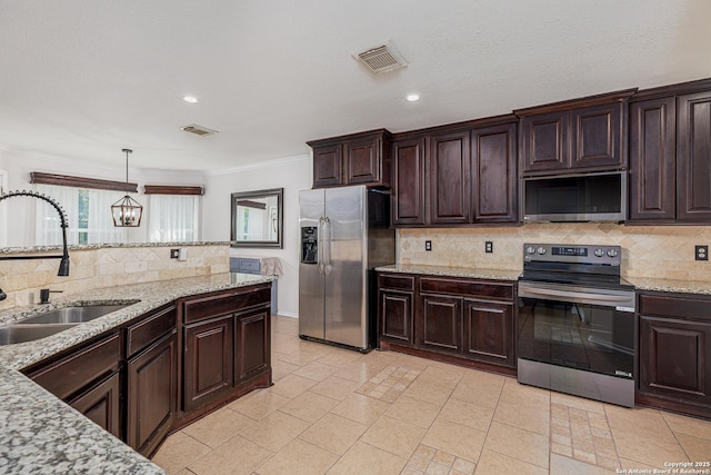 kitchen featuring visible vents, crown molding, stainless steel appliances, and a sink