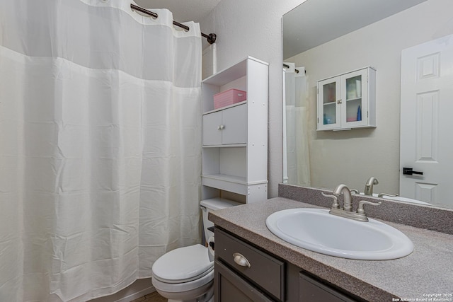 full bath featuring toilet and vanity
