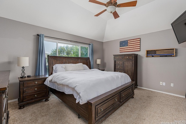 bedroom featuring light carpet, vaulted ceiling, baseboards, and a ceiling fan