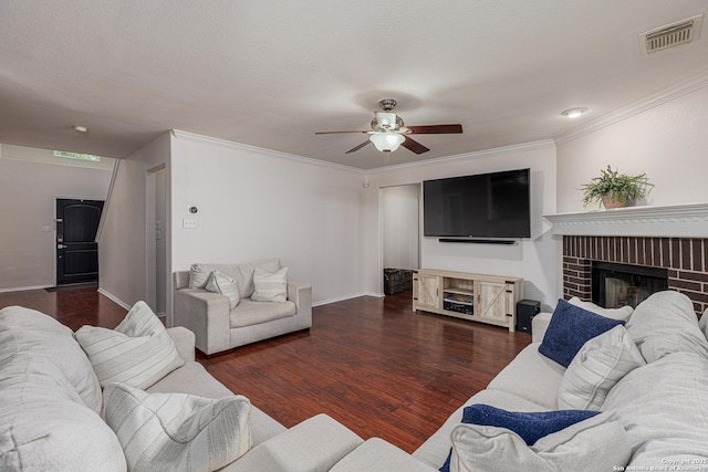 living area featuring a fireplace, wood finished floors, visible vents, and ceiling fan