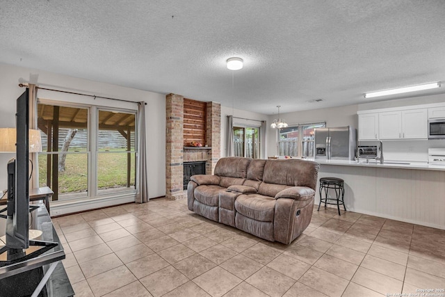 5906 Kissing Oak, San Antonio, TX 78247 - living room with a textured ceiling, a toaster, a notable chandelier, and light tile patterned floors