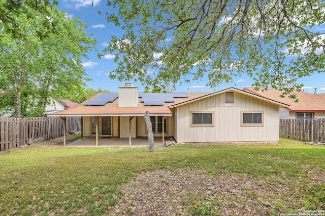 5906 Kissing Oak, San Antonio, TX 78247 - back of house featuring a lawn, a fenced backyard, a patio area, and solar panels