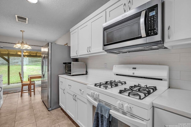 5906 Kissing Oak, San Antonio, TX 78247 - kitchen featuring a textured ceiling, visible vents, white cabinetry, and stainless steel appliances
