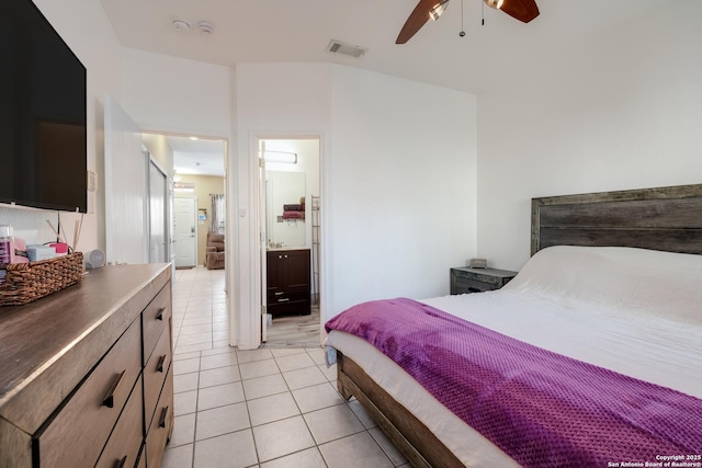 bedroom with ceiling fan, ensuite bath, visible vents, and light tile patterned floors
