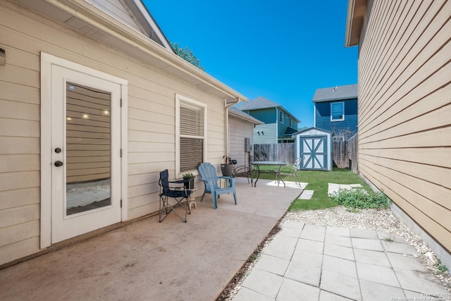 view of patio featuring a storage shed, an outbuilding, and a fenced backyard