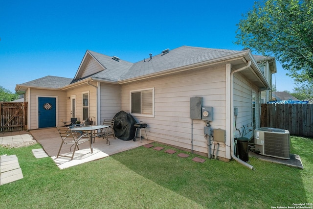 back of property with central air condition unit, a yard, a patio, and a fenced backyard