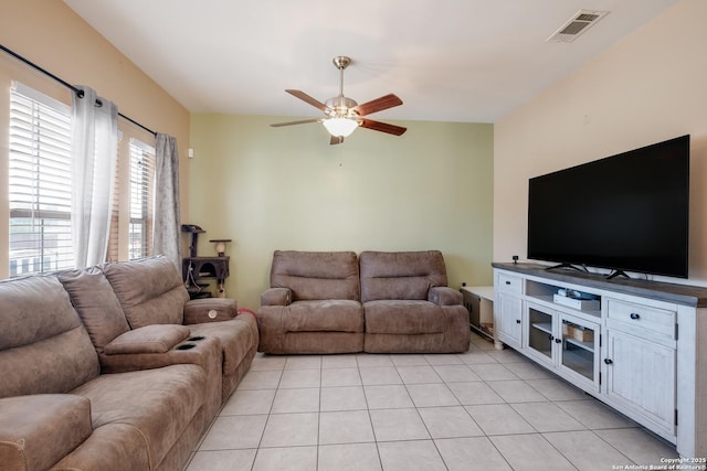 living area with light tile patterned flooring, visible vents, and a ceiling fan
