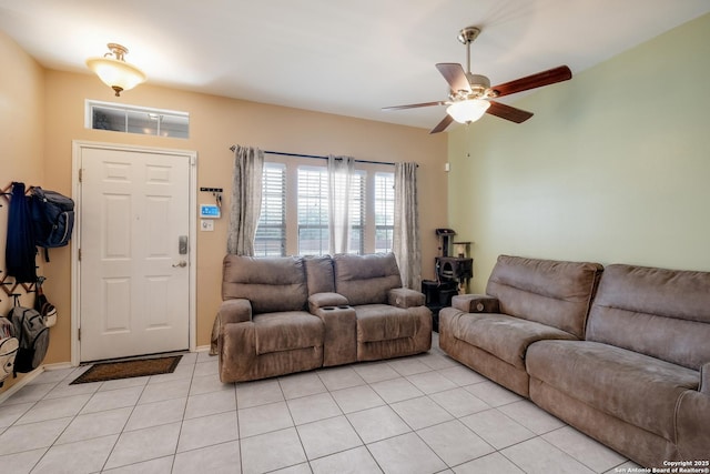 living room with baseboards, ceiling fan, and light tile patterned flooring