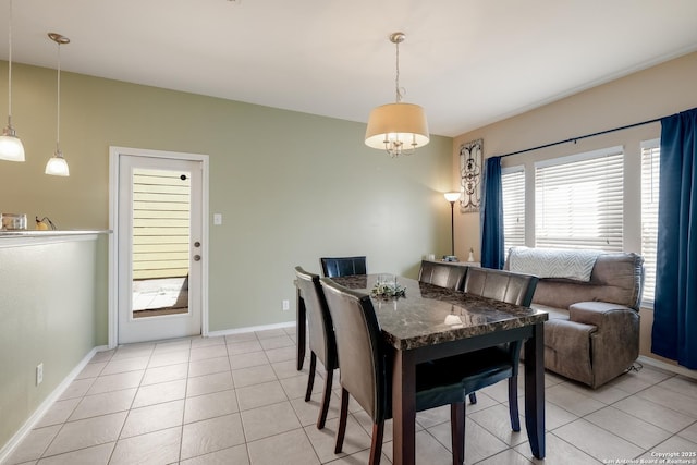 dining area with baseboards and light tile patterned floors