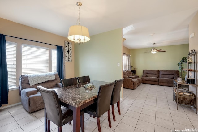 dining area with a ceiling fan and light tile patterned floors