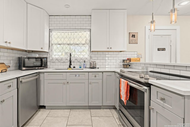371 Sprucewood Ln, San Antonio, TX 78216 - kitchen featuring light countertops, decorative backsplash, stainless steel appliances, and a sink