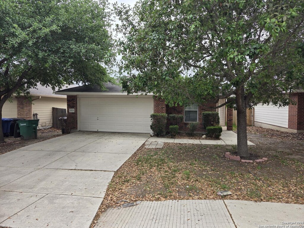 9506 Everton, San Antonio, TX 78245 - view of front of property featuring brick siding, driveway, and a garage