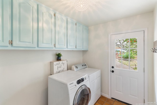 laundry room featuring cabinet space, baseboards, washer and dryer, and light tile patterned flooring