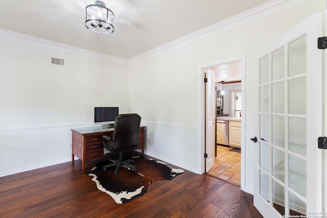 office with baseboards, wood finished floors, visible vents, and ornamental molding