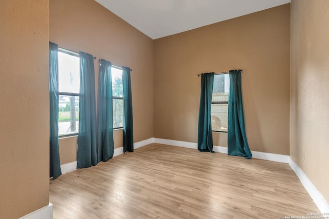unfurnished room with light wood-style floors and baseboards