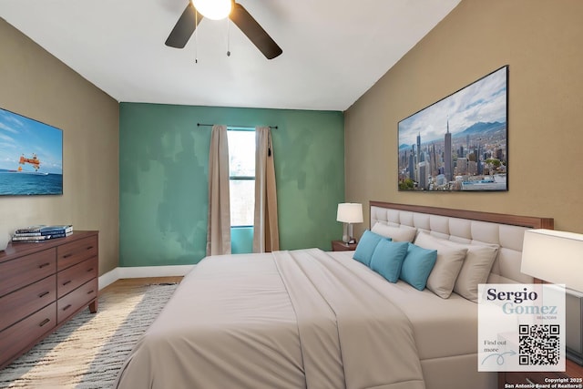 bedroom featuring a ceiling fan, baseboards, and wood finished floors