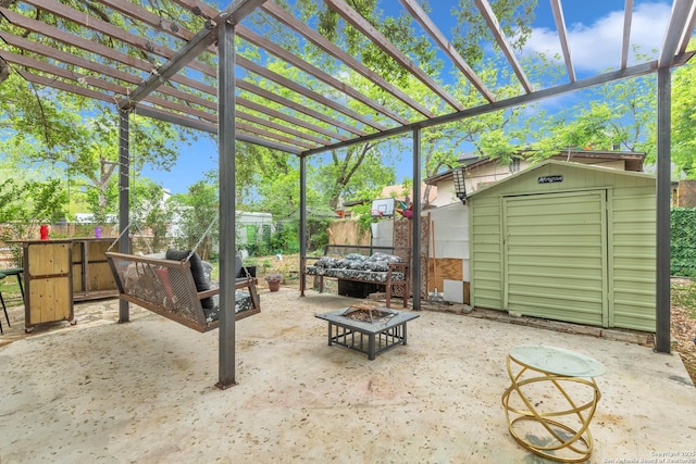 view of patio with an outdoor fire pit, a storage shed, and an outbuilding