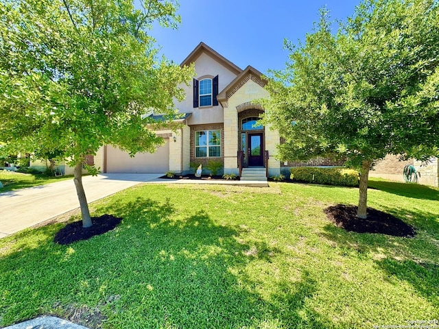 9035 Monument Parke, San Antonio, TX 78254 - traditional home with a front lawn, concrete driveway, brick siding, an attached garage, and stucco siding