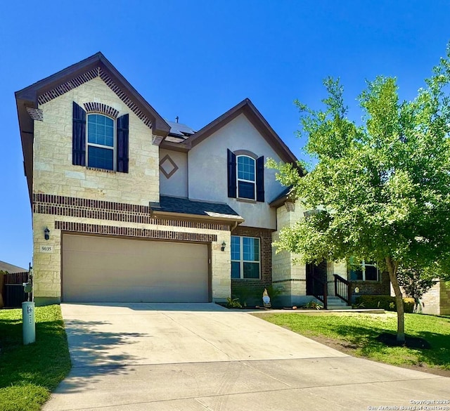 9035 Monument Parke, San Antonio, TX 78254 - view of front of home with stone siding, an attached garage, roof mounted solar panels, and concrete driveway